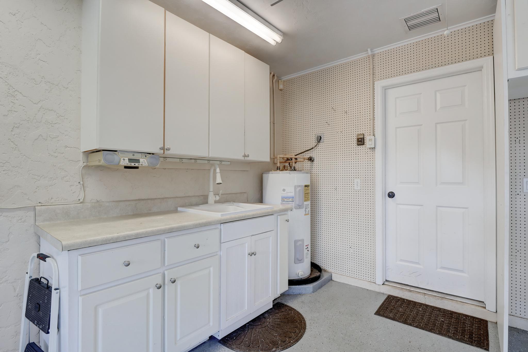 There is a Wash Sink and Extra Cabinets and Counter Space in the Garage