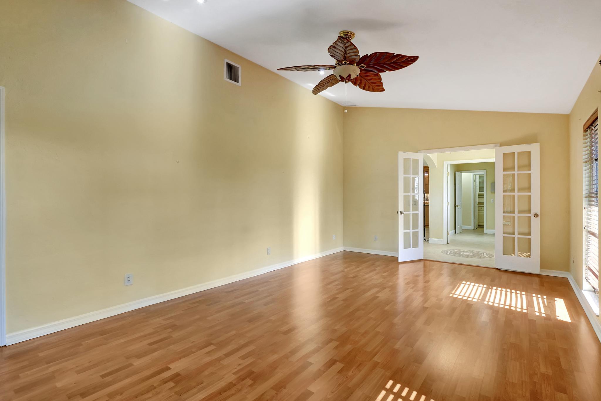 Main Bedroom With Double Doors and Ceiling Fan 