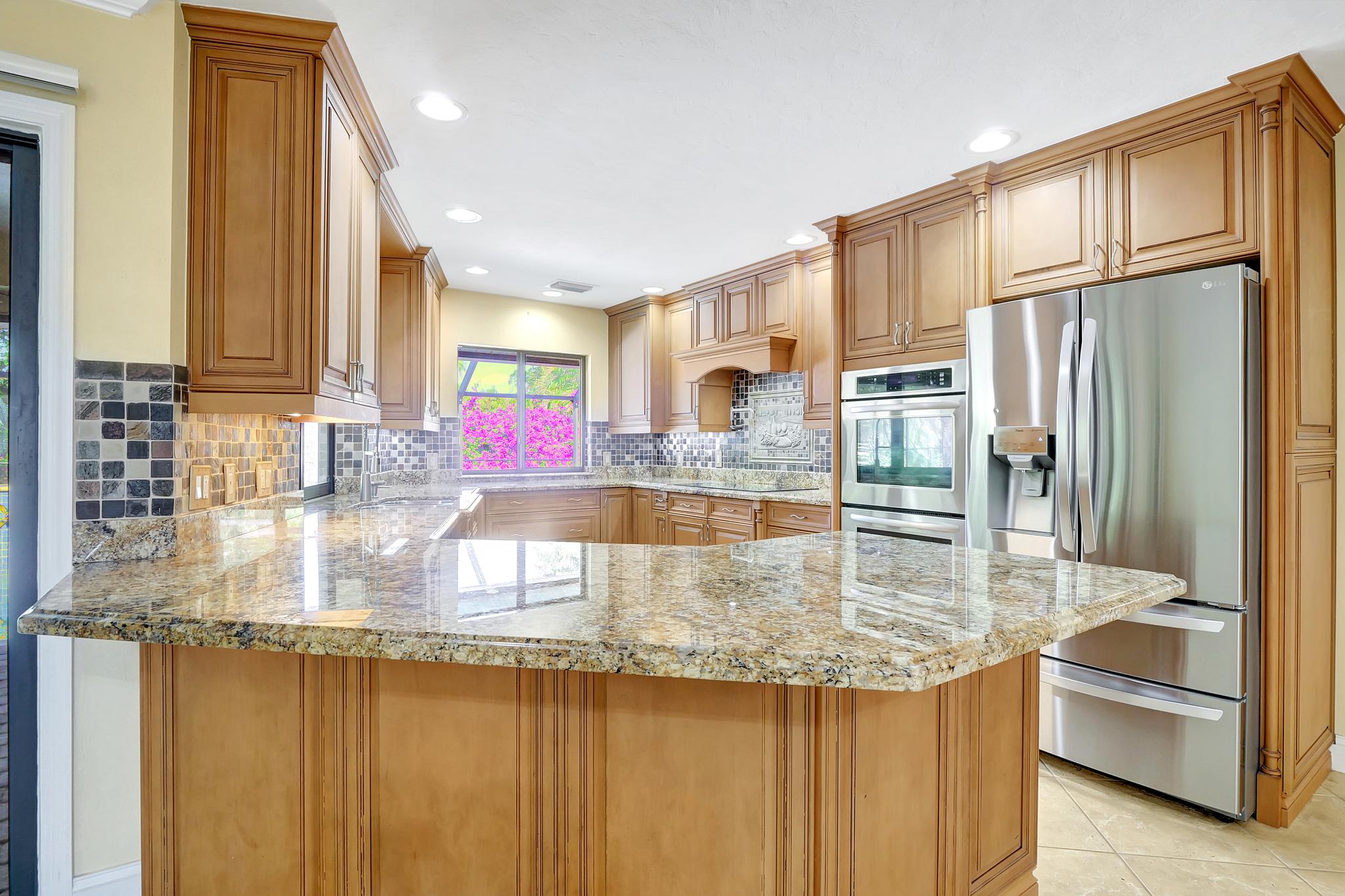 The Kitchen Features Stainless Appliances and Granite Counter Tops