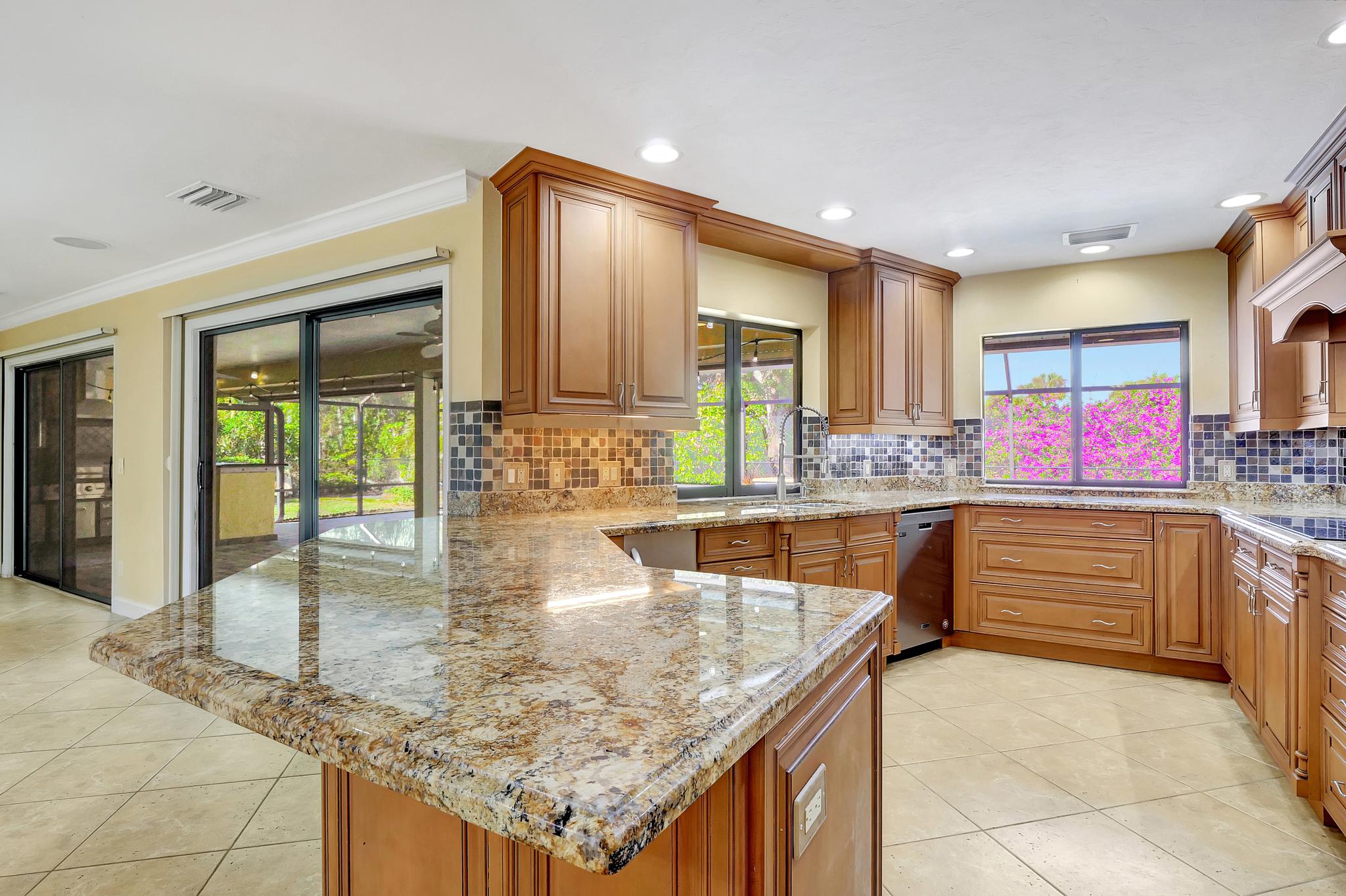 The Kitchen Looks to the Pool, the Backyard and Out to the Dining and Family Room Spaces