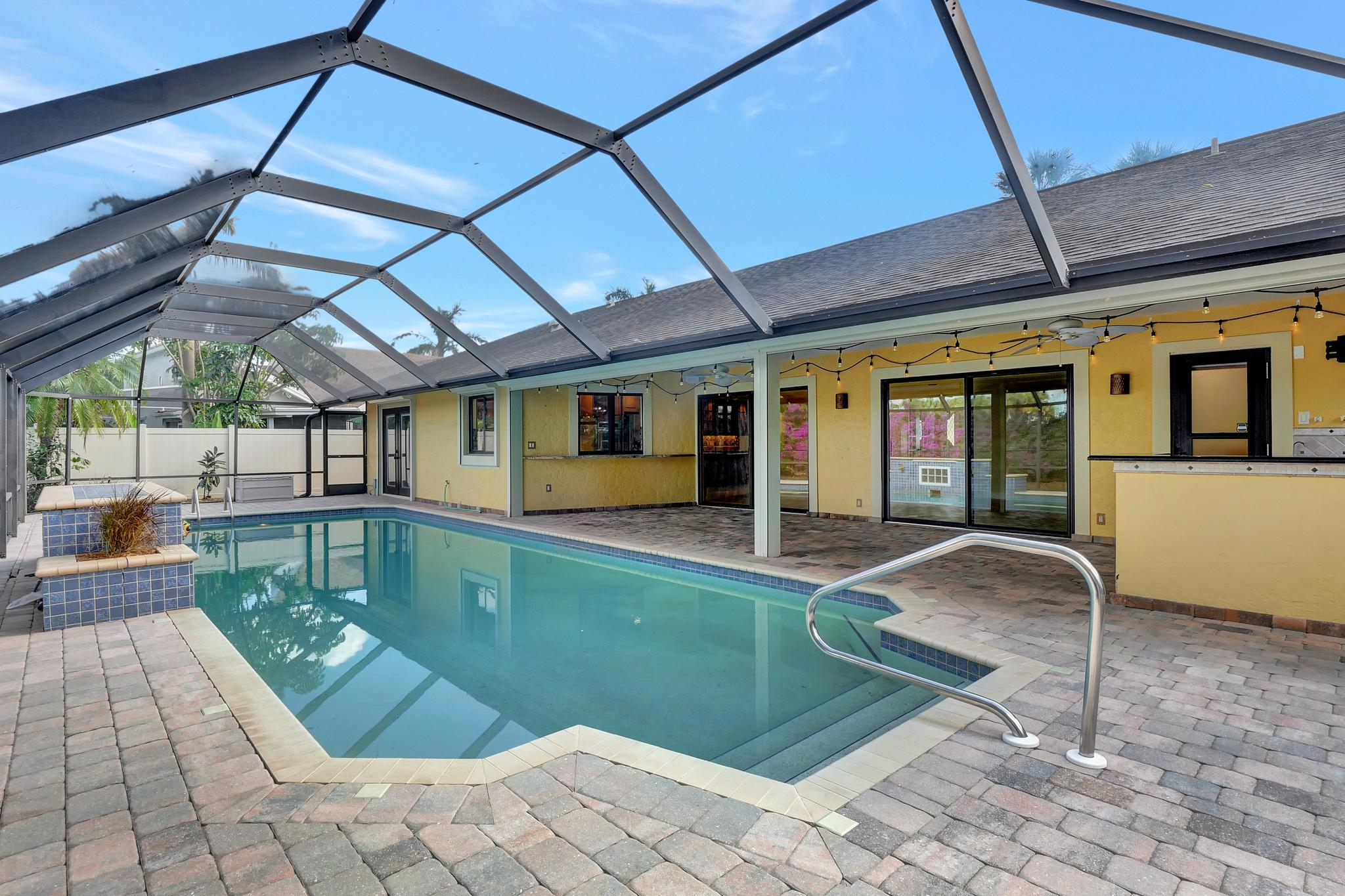 There is a Large Under Roof Outdoor Area With a Full Outdoor Kitchen