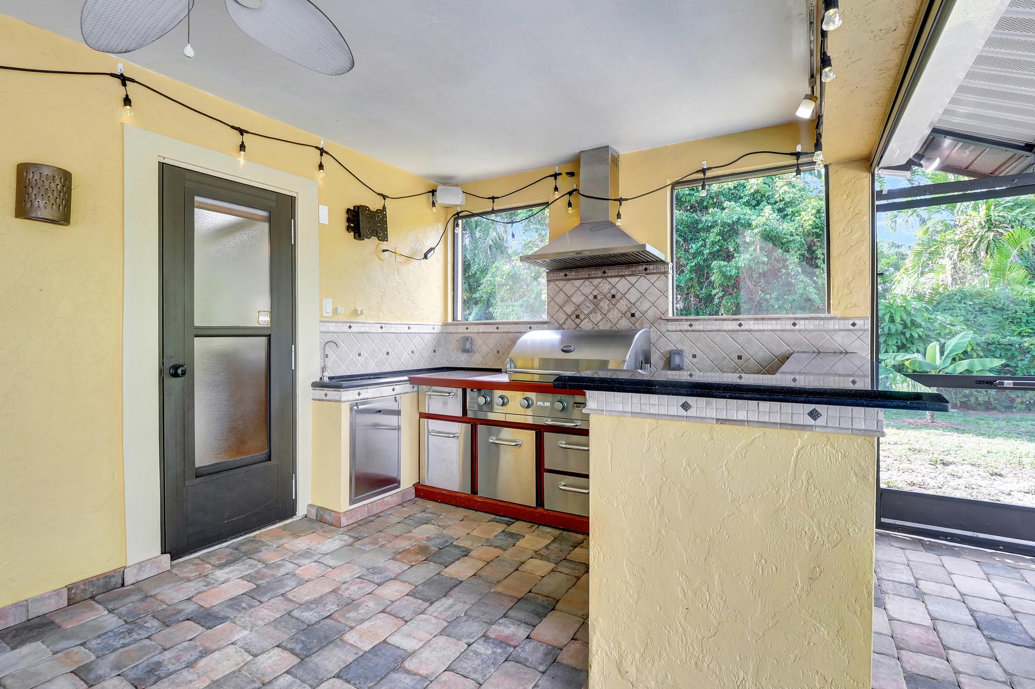 The Black Door Leads to the Main Bathroom From/To the Outdoor Kitchen and Pool Deck