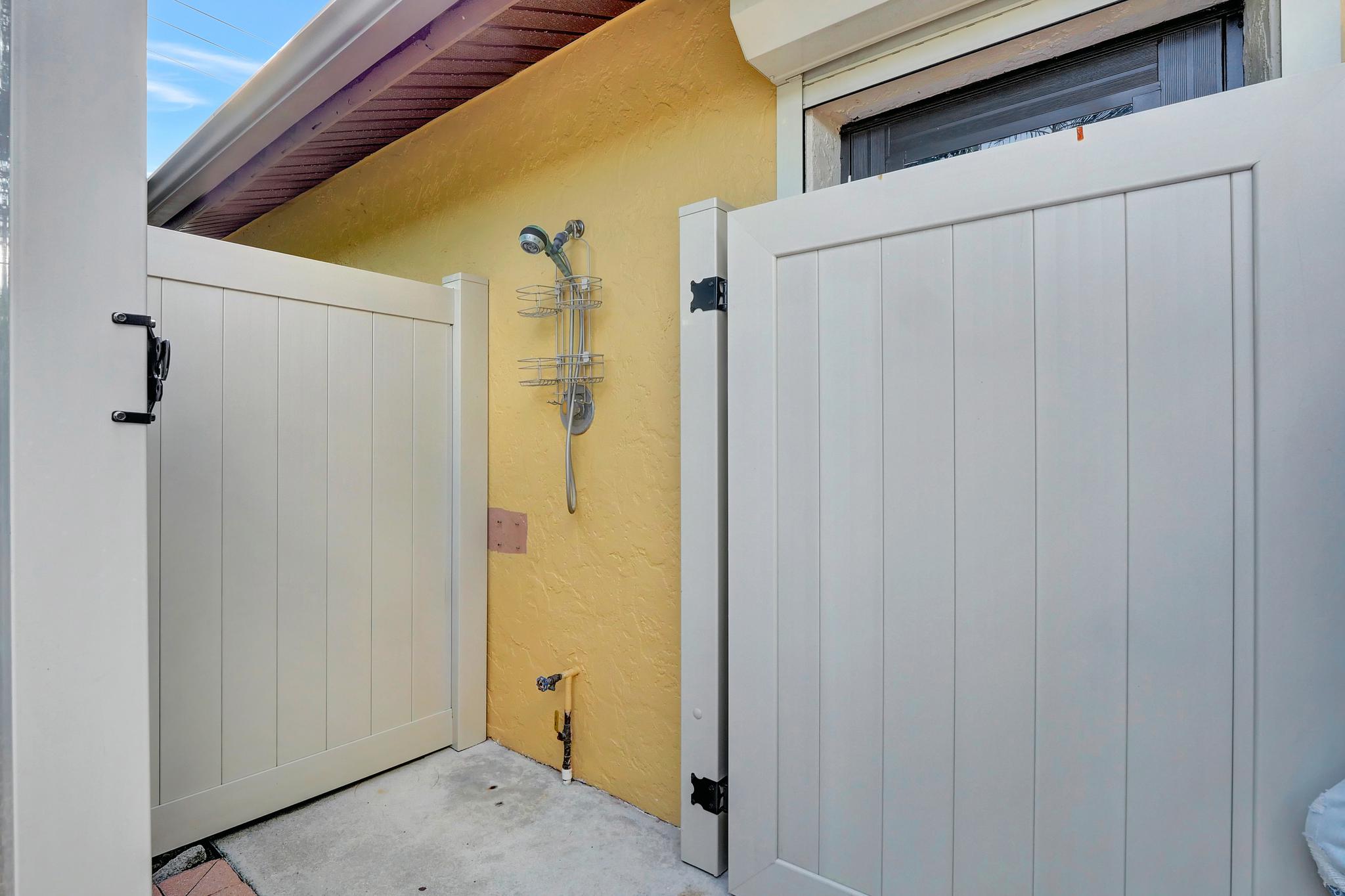 The Outdoor Shower Conveniently Located Outside the Garage And is Great To Wash Off After A Day At the Beach
